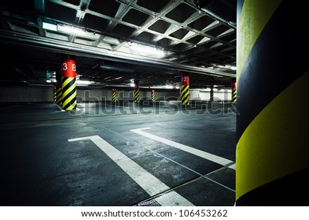 Parking garage underground, industrial interior. Neon light in bright industrial building.