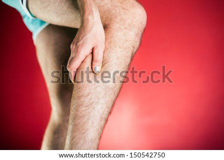 Running physical injury, leg calf pain. Runner sore body after exercising, red background