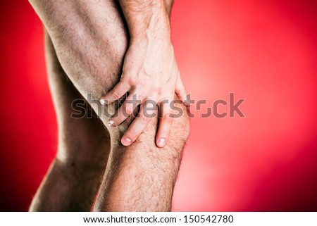 Running physical injury, leg knee pain. Runner sore body after exercising, medical examining and massage, red background