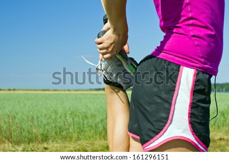 Woman Running On Country Road And Exercising Stretching Outdoors In Summer Nature. Female Runner Sport And Fitness.