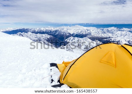 Expedition camping in tent on Mount Elbrus trail to the top, Mountain landscape in autumn or winter in Caucasus Mountains i Russia and Georgia, view from Elbrus(5642m) slopes on Pastuchov Rocks 4700m