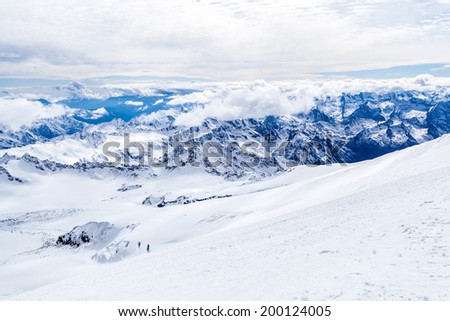 Mountain landscape, Elbrus region in autumn or winter in Caucasus Mountains i Russia and Georgia. Mountain ridge over blue sunny sky, Russia