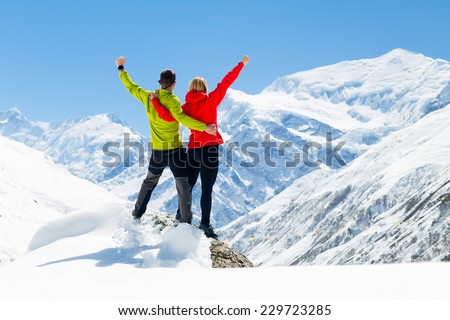 Hiking woman and success in mountains. Fitness and healthy lifestyle outdoors in winter nature