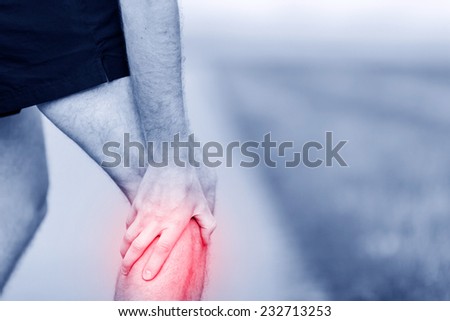 Runner leg and muscle pain during running training outdoors in summer nature, sport jogging physical injury, workout. Health and fitness concept