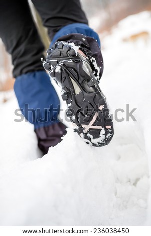People hiking walking in white winter forest on deep snow. Recreation and healthy lifestyle outdoors in nature, motivational and healthy concept, trekking boots.