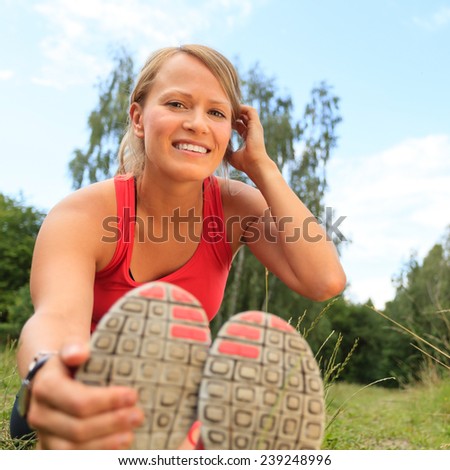 Happy Smiling Young Woman Runner Exercising and Stretching Fitness in Summer Nature Outdoors, Healthy Lifestyle Activity Motivation and Inspiration Outside. Training and Working Out Healthy Lifestyle