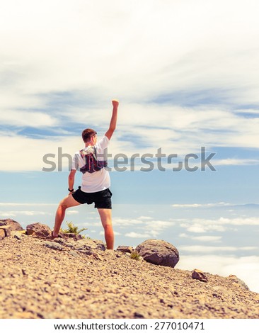 Trail runner, man and success in mountains. Motivation and inspiration on mountains peak. Running, sports, fitness and healthy lifestyle outdoors in summer nature