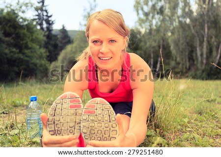 Happy Smiling Young Woman Runner Exercising and Stretching Fitness in Summer Nature Outdoors, Healthy Lifestyle Activity Motivation and Inspiration Outside. Training and Working Out Healthy Lifestyle