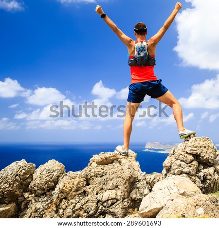 Success motivation happy man running or hiking, achievement successful and happiness concept, accomplished man celebrating with arms up raised outstretched climbing or trail running, healthy lifestyle
