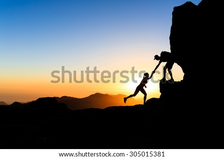 Teamwork couple helping hand trust help silhouette in mountains. Team of climbers teammates man and woman help each other on mountain top, inspiration and motivation together, inspirational landscape