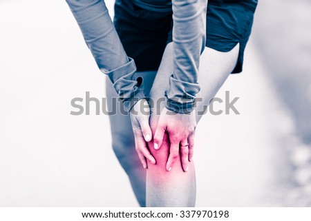 Runners knee leg pain, woman holding sore and overtrained painful knee, sprain or cramp ache filled with red pink bright place. Overtraining injured person when exercising or running outdoors.
