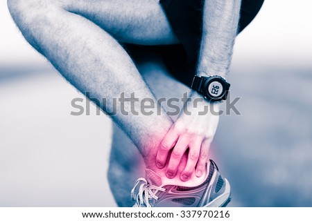 Ankle leg pain, man holding sore and painful foot muscle, sprain or cramp ache filled with red pink bright place. Overtrained injured person when training exercising or running outdoors.