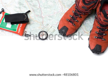 Hiking shoes and equipment on map with compass(clipping path)