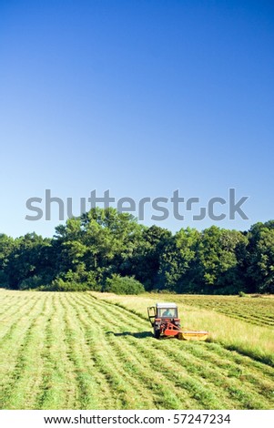 Tractor working on green grass field