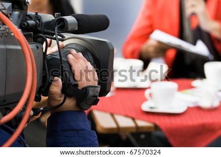Live broadcasting, television operator with camera. Selective focus on hand