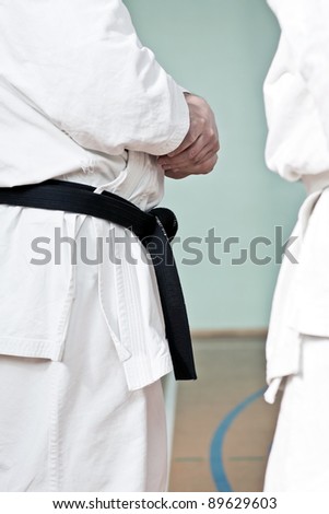 Karate training, brown belt man at gym, gear closeup