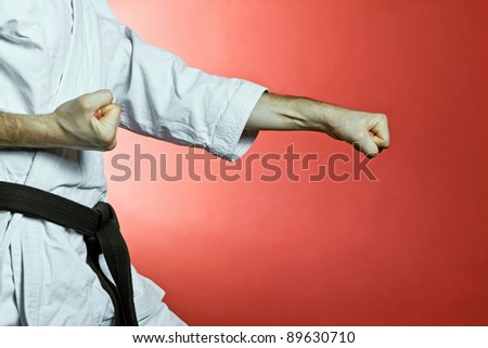 Karate training at gym over red background