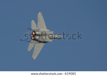 F-15 in flight in banking turn with afterburner flames visible
