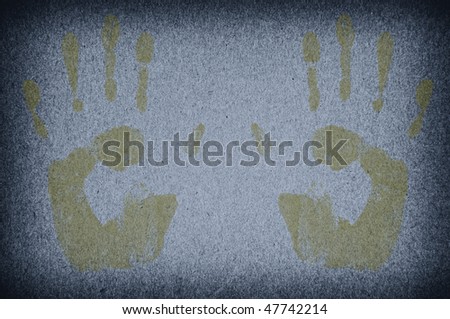 Imprints of hands on a paper with a dark blue background