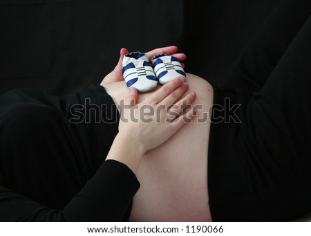 Mom Holding Baby Shoes