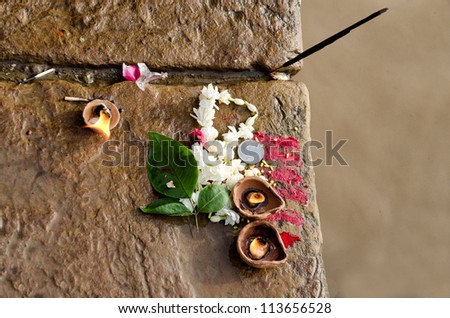Candle, flower, incense and red powder offered to the river Ganges