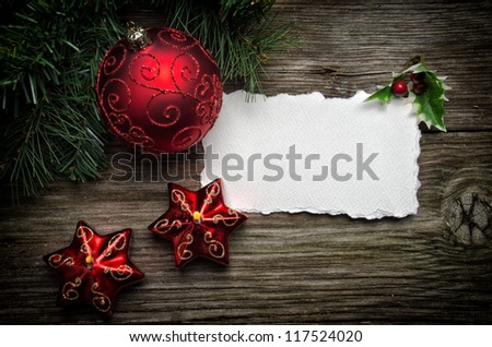 Christmas greeting Card with ball and candles on wooden top