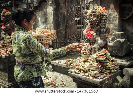 UBUD INDONESIA-Aug 29 unidentified woman praying god in Ubud Bali Indonesia on 29 aug 2009 Every morning women bring flowers and incense to their gods UBUD INDONESIA-Aug 29 unidentified woman praying god in Ubud Bali Indonesia on 29 aug 2009 Every morning women bring flowers and incense to their gods