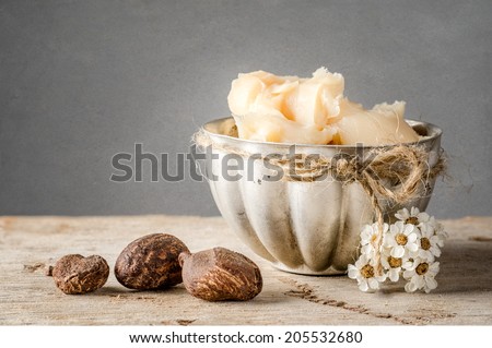 Cup of shea butter with shea nuts