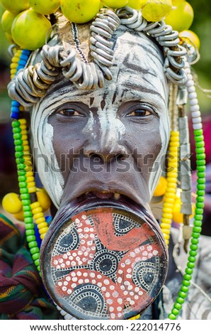JINKA, ETHIOPIA, - 10 AUGUST: unidentified woman from Mursi tribe with big lip plate, in  Jinka Ethiopia, on 10 August 2014. The bigger the lip plate, the more beautiful the woman is considered.