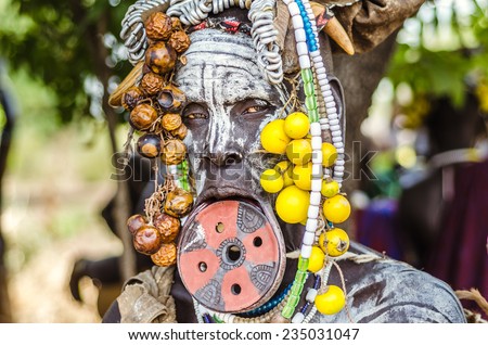JINKA, ETHIOPIA - 10 AUGUST: unidentified woman from Mursi tribe with big lip plate, in  Jinka Ethiopia, on 10 August 2014. Between Mursi tribe, big lip plates are signs of beauty for a woman