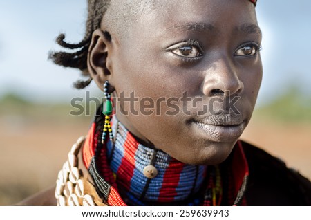 TURMI, ETHIOPIA - 12 AUGUST: portrait of unidentified Hamer tribe woman, Omo valley, 12 august 2014. Hamer woman usualy comb their hairs with soil and wear many colored necklace