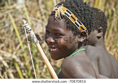 LAKE EYASI, TANZANIA - AUGUST 14:  unidentified young hunter from Hadza tribe with his bow, ready for the hunt, on august 14, 2010. Hadza people are an ethnic group from north Tanzania