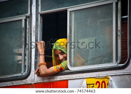 JAIPUR, INDIA-AUGUST 21: unidentified young woman smiling at the window on the bus from Jaipur to Udaipur, in Jaipur, august 21, 2008.