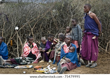 MKURU, TANZANIA - AUGUST 12: unidentified women from Masai tribe sell handmade jewels in their boma on august 12, 2010. Boma is the typical masai home where live a man with all his wives and children
