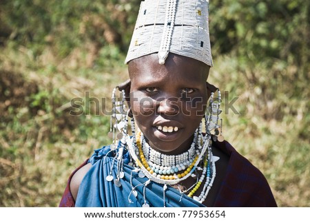 EMPAKAI LAKE, TANZANIA - AUGUST 15: Unidentified Masai woman adorned with jewels in Lake Empakai, Tanzania, August 15, 2010. Masai women  wear many handmade ornament  especially for head and feet.