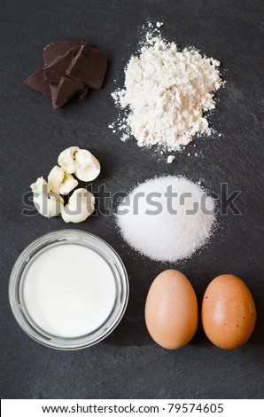 Ingredients for a cake on a black natural stone