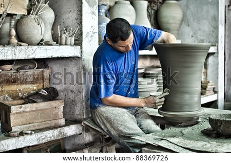 FEZ, MOROCCO-OCTOBER 24: Unidentified man makes a pottery in Fez, Morocco, on October 24, 2011. Fez is famous for its ceramics that are all handmade and hand painted.