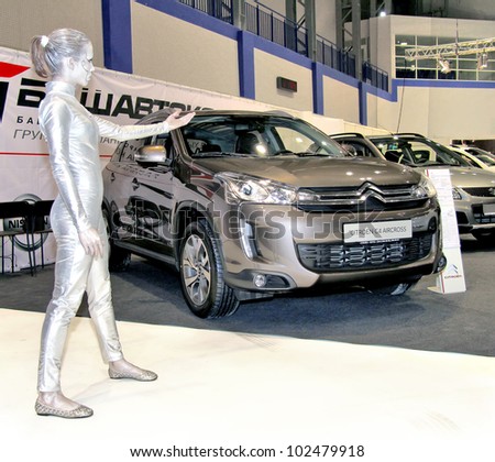 UFA, RUSSIA - MAY 14: Female model posing near a Citroen cars showroom at the annual Motor show \