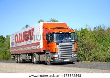 CHELYABINSK REGION, RUSSIA - MAY 18, 2008: Orange Scania R420 trailer truck at the interurban road.
