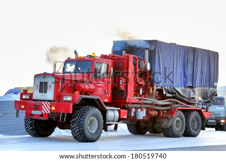 NOVYY URENGOY, RUSSIA - FEBRUARY 24, 2013: Red Kenworth T800 truck of the Halliburton oil field service company at the city street.