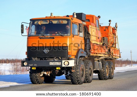 NOVYY URENGOY, RUSSIA - FEBRUARY 23, 2013: Orange URAL 5323 oil field service truck at the city street.