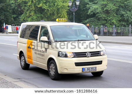 BERLIN, GERMANY - SEPTEMBER 12, 2013: Yellow Volkswagen Caravelle taxi at the city street.