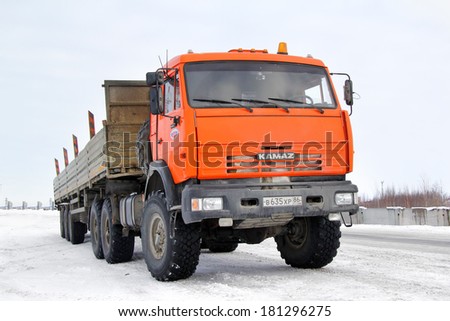 NOVYY URENGOY, RUSSIA - MARCH 12, 2014: Red KAMAZ 44108 off-road semi-trailer truck at the interurban road of the Russian Extreme North.