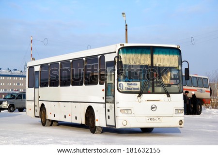 NOVYY URENGOY, RUSSIA - FEBRUARY 9, 2013: White LIAZ 5256 interurban bus at the city street.