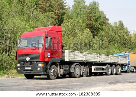 CHELYABINSK REGION, RUSSIA - MAY 24, 2008: Red MAZ 6430 semi-trailer truck at the interurban road.