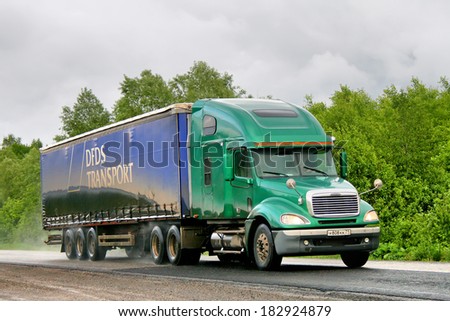 CHELYABINSK REGION, RUSSIA - JUNE 6, 2008: Green Freightliner Columbia semi-trailer truck at the interurban road.