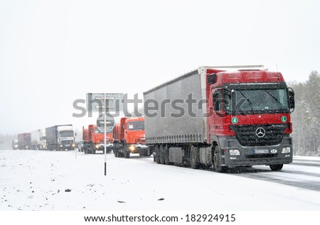CHELYABINSK REGION, RUSSIA - SEPTEMBER 28, 2008: Traffic jam at the interurban road caused by a heavy snowstorm in september.