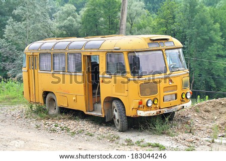 KRASNODAR KRAI, RUSSIA - JULY 17, 2009: Yellow PAZ 672M vintage bus near the forest.