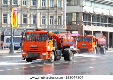 MOSCOW, RUSSIA - MAY 6, 2012: Red KAMAZ 53605 watering and cleaning machines at the city street.