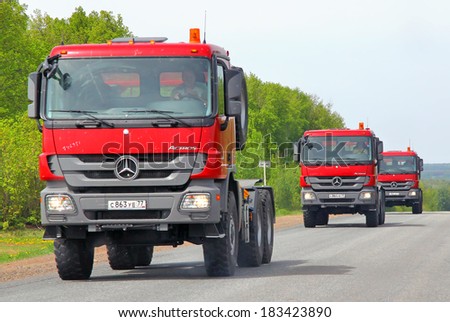 TATARSTAN, RUSSIA - MAY 20, 2013: Red Mercedes-Benz Actros semi-trailer trucks at the interurban road.